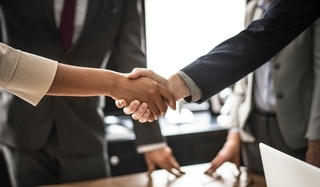 Sports agents shaking hands to celebrate a deal