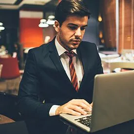 Young sports management professional working at a computer
